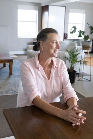 Relaxed Senior Woman in Bright Elegant Living Room
