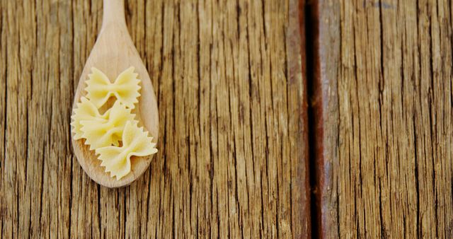 Wooden Spoon with Bowtie Pasta on Rustic Wooden Table - Download Free Stock Images Pikwizard.com