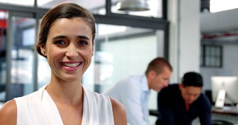 Confident Business Executive Smiling with Team in Office