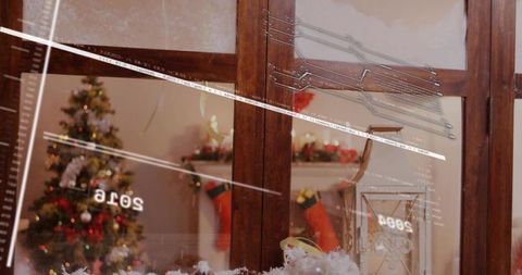 Warm Christmas living room showing through frosted wooden window panes with festive reflections