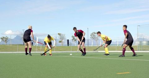 Dynamic Field Hockey Match in Action with Athletes Competing Outdoors