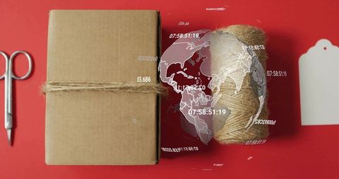 Wrapping kraft parcel with jute twine on red backdrop showing global tracking overlay
