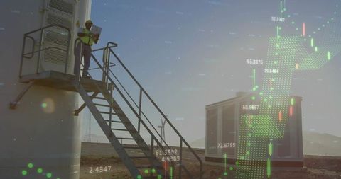 Field technician inspecting wind turbine data on tablet with digital analytics overlay