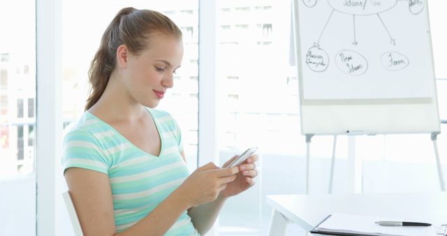 Young Woman Using Smartphone in Modern Office Environment - Download Free Stock Images Pikwizard.com