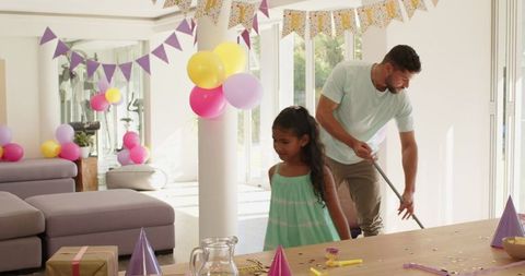 Father and Daughter Cleaning After Celebrating Birthday at Home
