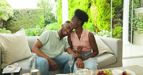 Young Couple Relaxing with Sparkling Water on Outdoor Patio