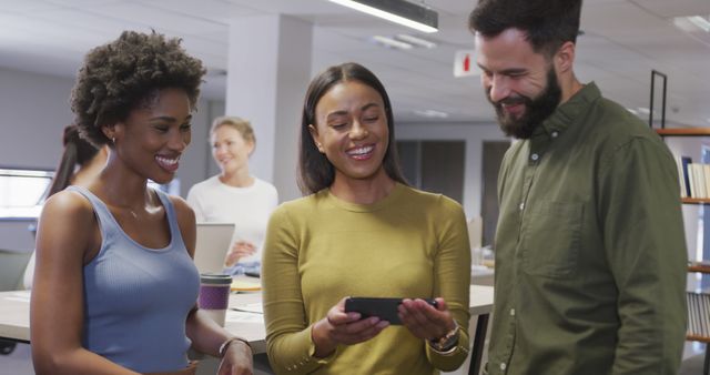 Group of Diverse Colleagues Smiling and Using Smartphone in Open Office - Download Free Stock Images Pikwizard.com