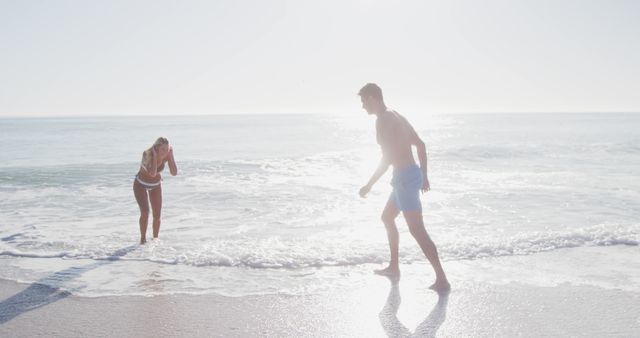 Couple Enjoying Beach Vacation in Bright Sunlight - Download Free Stock Images Pikwizard.com