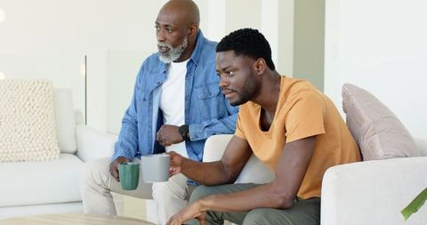 Father and Son Bonding Over Coffee in Modern Living Room