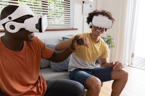 Friends Using Virtual Reality Headsets in Modern Living Room
