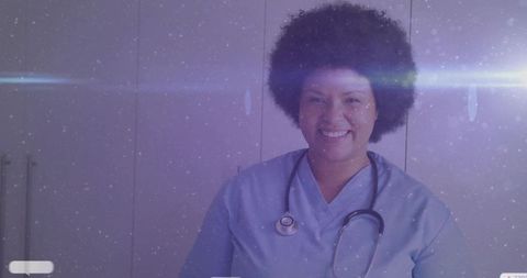 Smiling nurse in blue scrubs with stethoscope