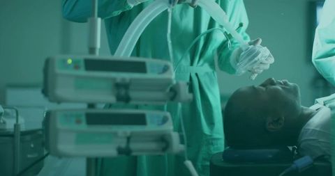 Anesthetist preparing for surgery in operating room