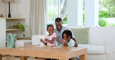 Happy Family Time: Children Drawing and Laughing at Home