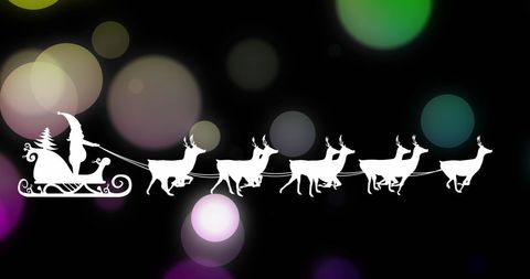 Silhouette of Santa on Sleigh with Reindeer at Christmas