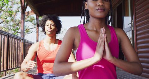 Couple Practicing Yoga Meditation on Cabin Deck