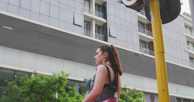 Young Woman Waiting at Traffic Light in Modern Urban Area - Download Free Stock Images Pikwizard.com