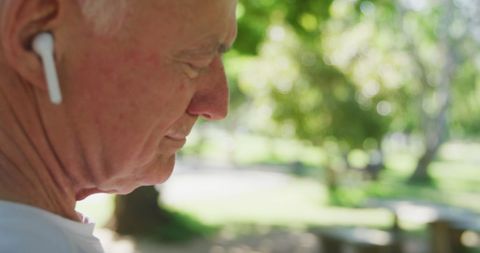Elderly Man Enjoying Music in Park