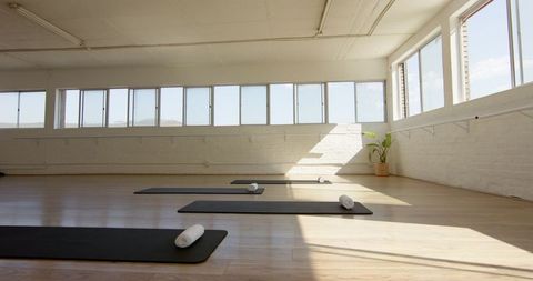 Relaxing Yoga Studio Interior with Sunlight Streaming through Windows - Download Free Stock Images Pikwizard.com