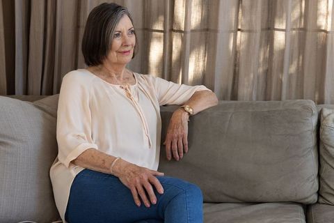 Elegant Senior Woman Relaxing on Cozy Living Room Sofa