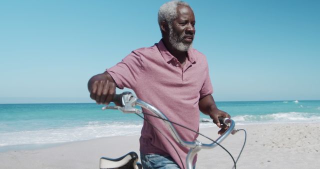 Senior Man with Bicycle on Beach Shoreline Enjoying Sunny Day - Download Free Stock Images Pikwizard.com