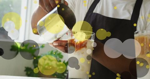 Barista Crafting Iced Coffee with Digital Bubble Overlay