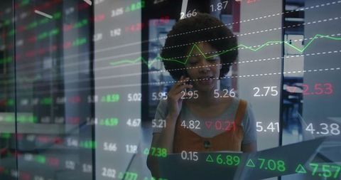 Businesswoman Analyzing Financial Markets on Smartphone and Laptop