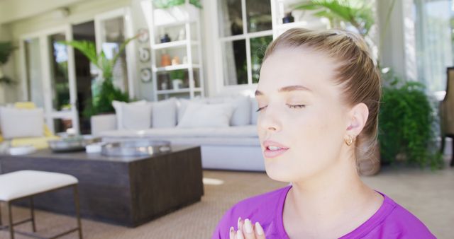 Young Woman Meditating Peacefully in Modern Home - Download Free Stock Images Pikwizard.com