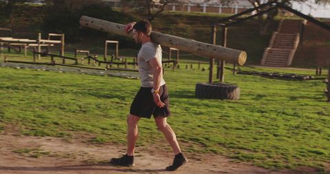 Man Carrying Heavy Log Outdoors for Intense Workout - Download Free Stock Images Pikwizard.com