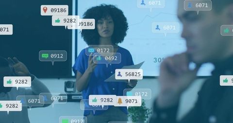Female presenter delivering office presentation with social engagement icons and data charts