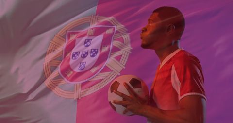 Soccer Player Holding Ball Against Portugal Flag