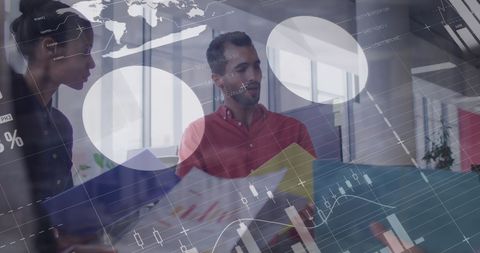 Business professionals reviewing reports in modern office