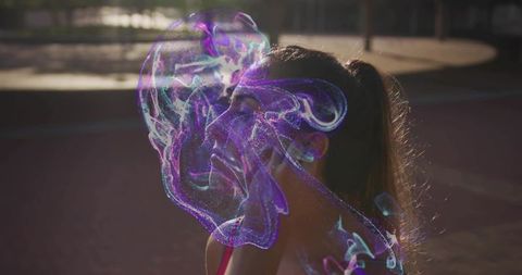 Standing female athlete in profile with purple hologram overlay on sunlit court rimlight
