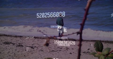 Solitary man on beach with floating codes, digital contemplation