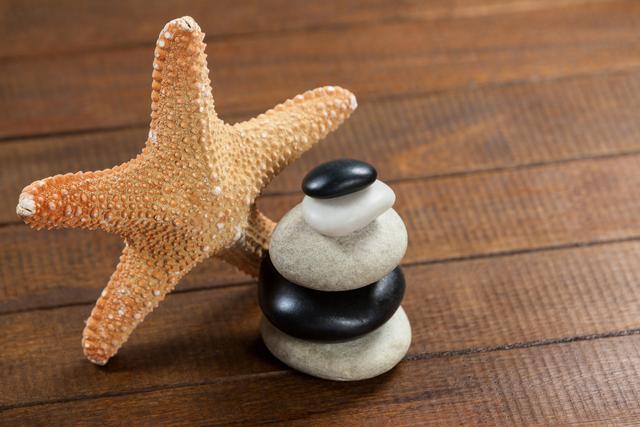 Zen Pebble Stones with Starfish on Wooden Surface - Download Free Stock Photos Pikwizard.com