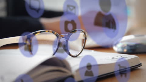 Tech Icons Hovering Over Books with Glasses and Keyboard
