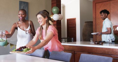 Friends Gather for Lively Home Celebration with Snacks and Laughter