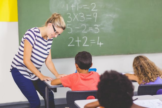 Teacher teaching mathematics to school kids in classroom at school