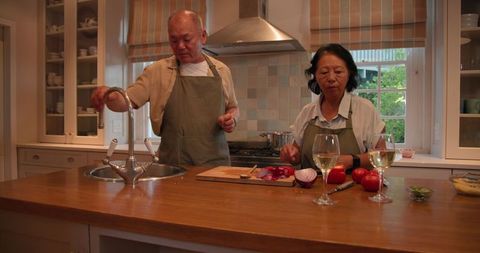 Senior couple enjoying culinary activities in modern kitchen