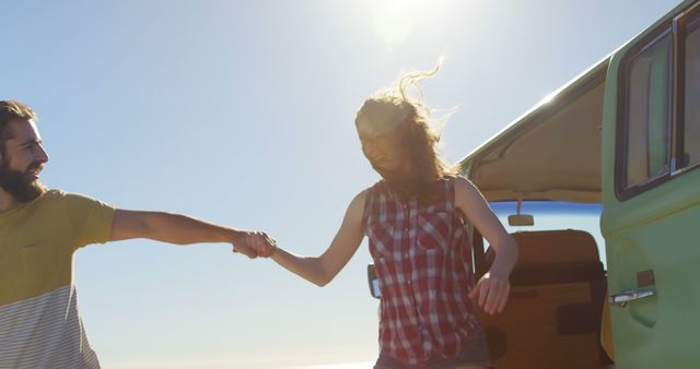 Happy young couple holding hands and getting out from the van - Download Free Stock Photos Pikwizard.com