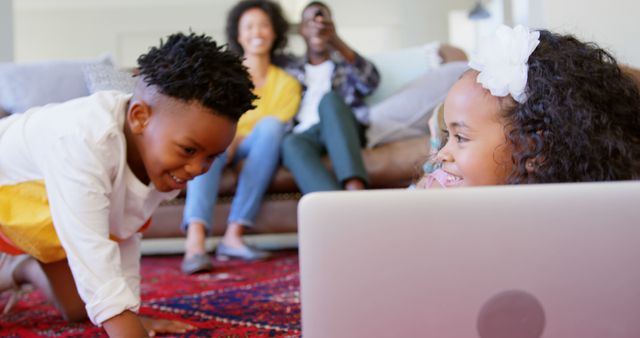 Children Playing with Laptop while Parents Relax on Couch - Download Free Stock Images Pikwizard.com