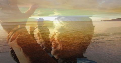 Senior Couple Enjoying Sunset Beach Walk With Surfboards