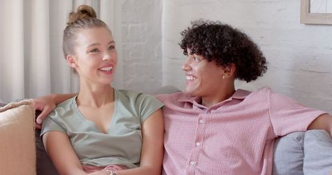 Diverse Couple Relaxing on Cozy Sofa in Living Room
