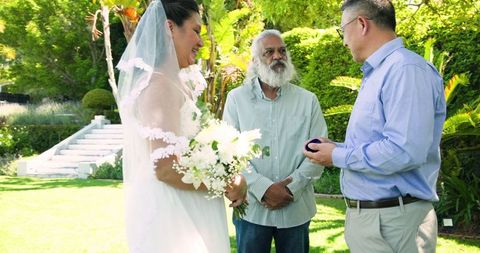Diverse senior couple wedding ceremony garden gathering
