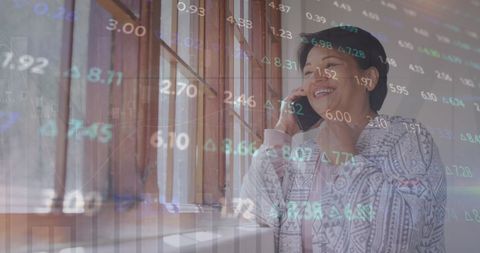 Businesswoman Communicating via Phone with Overlay of Stock Market Trends