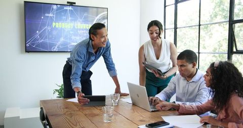 Team collaboration with laptop and presentation screen