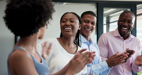 Enthusiastic Team Applauding Together in Modern Office Environment