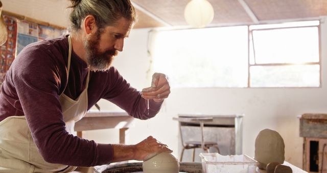 Male Artisan Crafting Pottery in Ceramics Studio - Download Free Stock Images Pikwizard.com