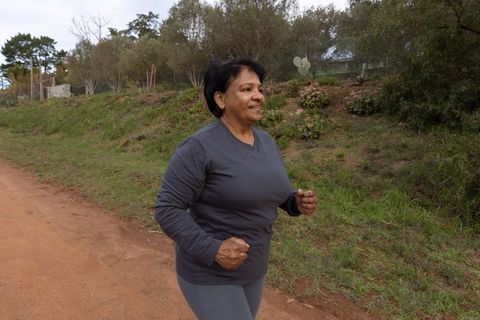 Senior Woman Enjoying Outdoor Jog on Rural Trail