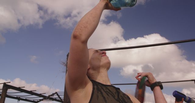 Woman Refreshing Herself with Water under Sunny Sky - Download Free Stock Images Pikwizard.com