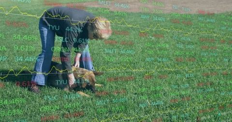 Senior woman caring for puppy in green field with graphical overlay